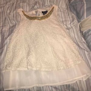 White and gold shirt.